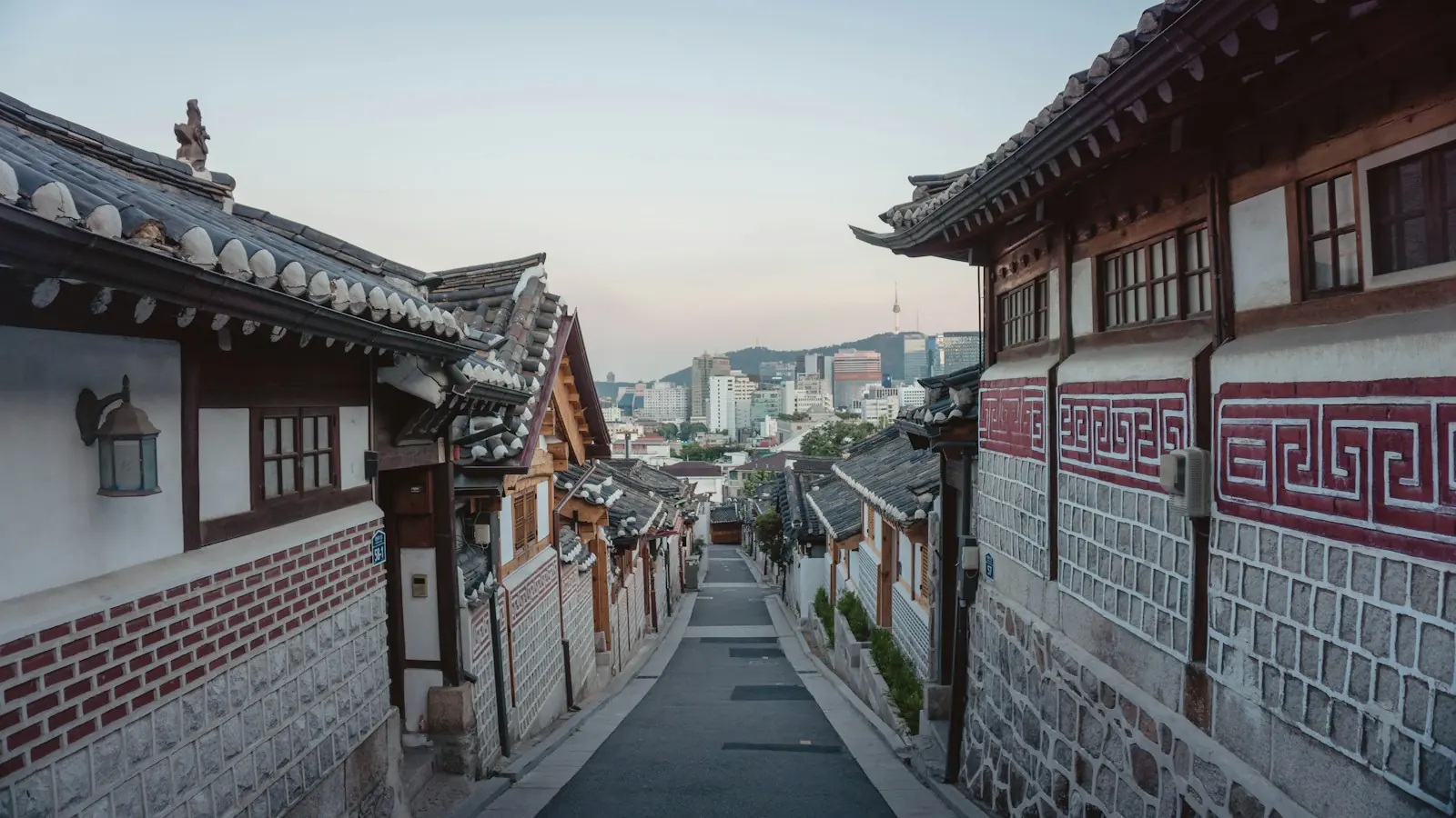 A quiet lane between tile-roofed hanok houses. You find streets like this a short walk from the palace.