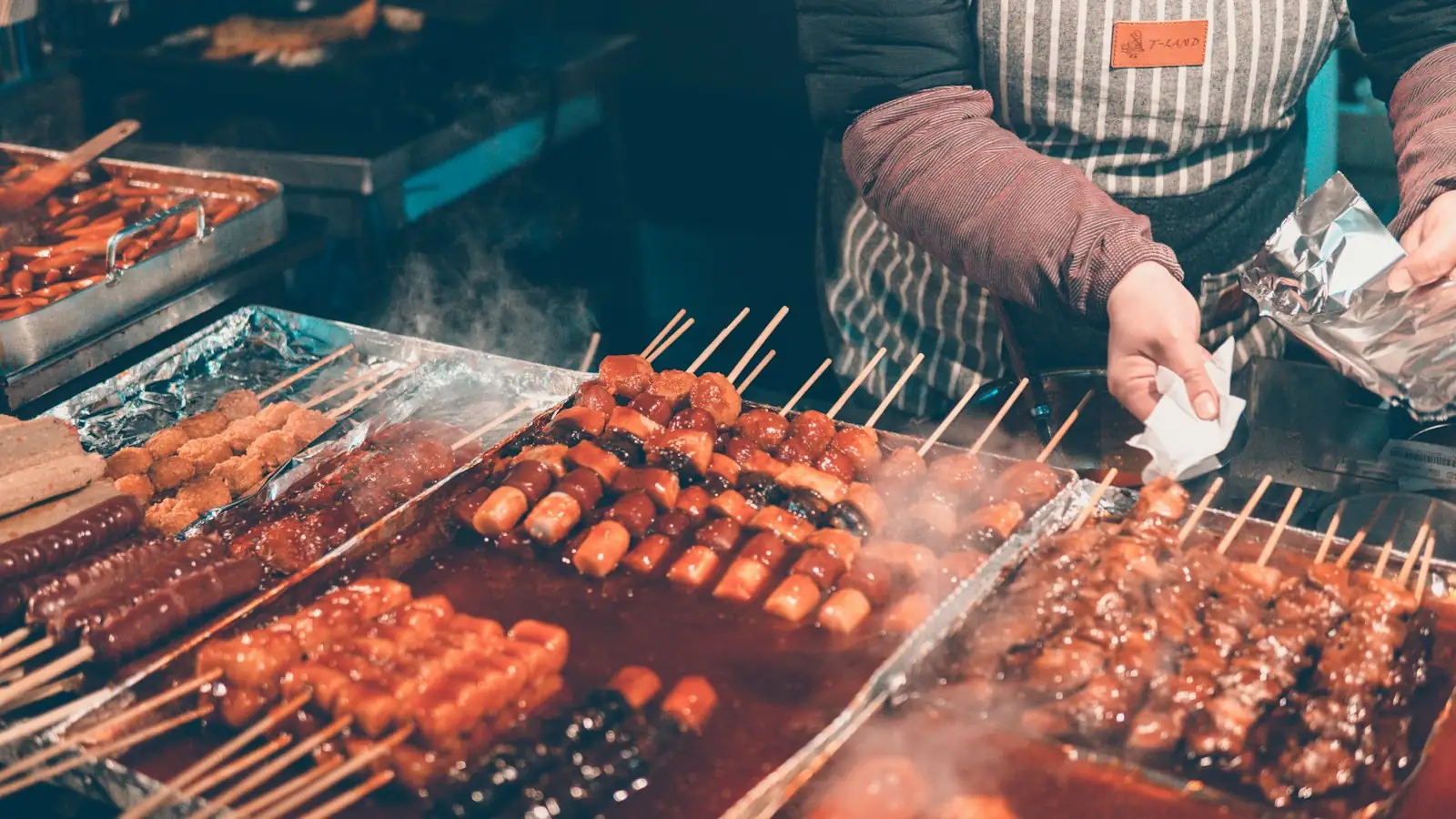 Skewers cooking at a Myeongdong street food stall